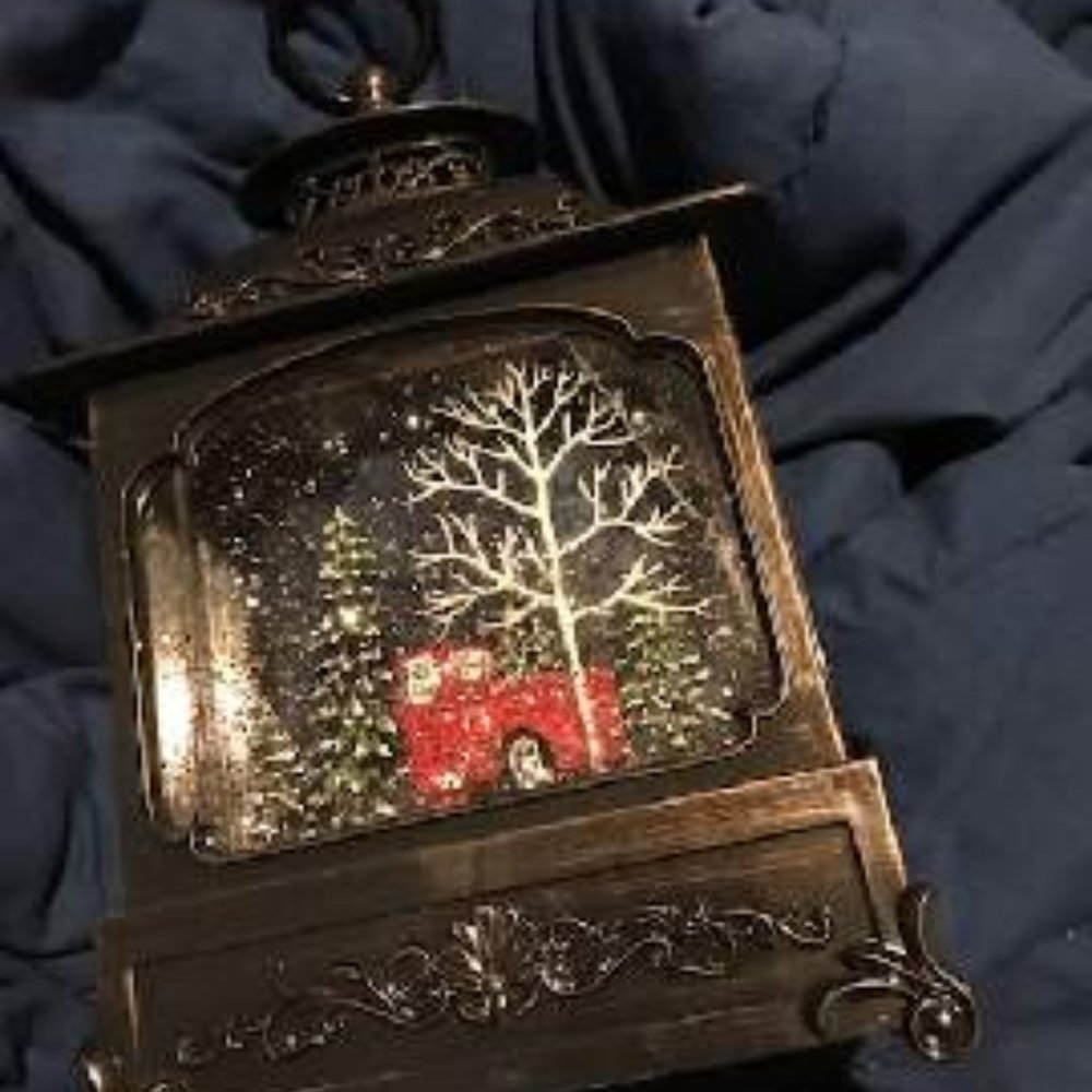 Illuminated lantern with holiday/winter scene inside